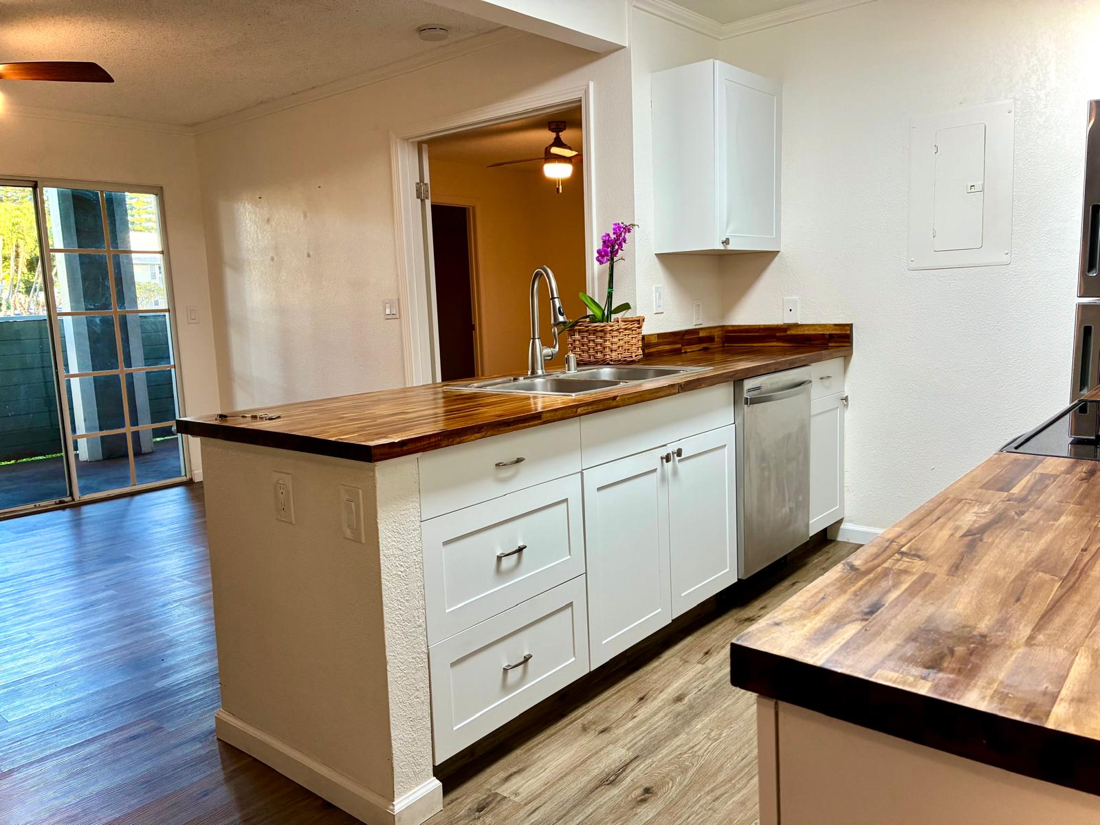 68-3883 Lua Kula Street, Unit 2102 Waikoloa, HI 96738 - Photo 4 of 21 a kitchen with sink cabinets and wooden floor