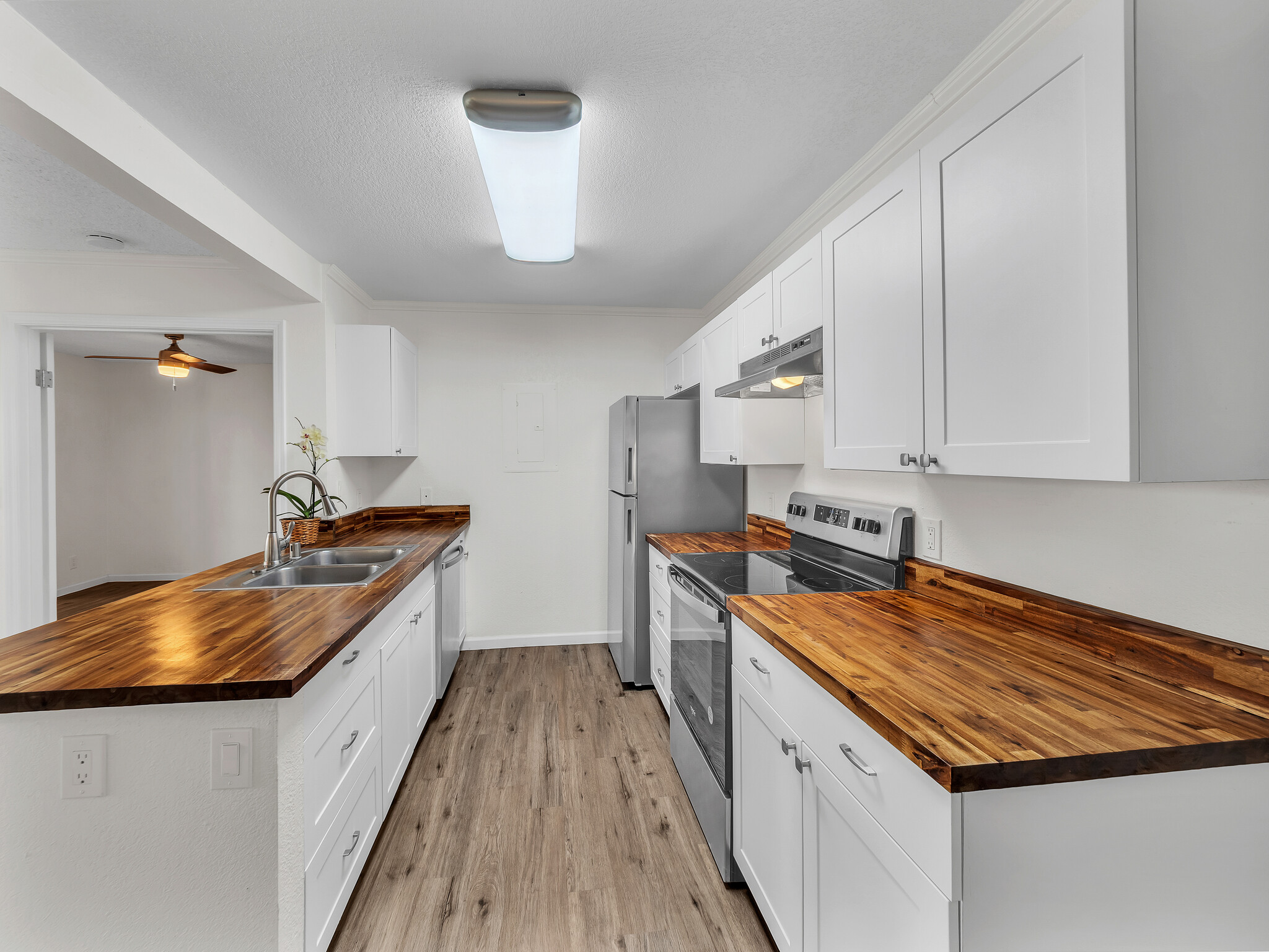 68-3883 Lua Kula Street, Unit 2102 Waikoloa, HI 96738 - Photo 5 of 29 a kitchen with stainless steel appliances granite countertop a sink and a stove