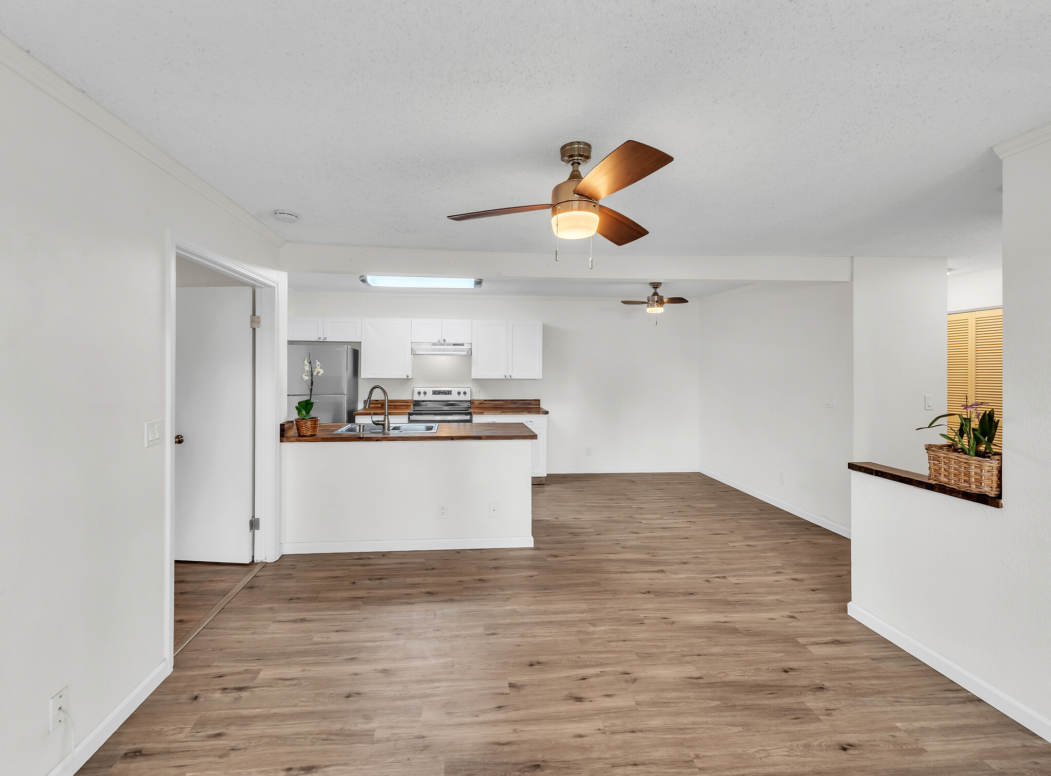 68-3883 Lua Kula Street, Unit 2102 Waikoloa, HI 96738 - Photo 6 of 29 a view of a kitchen with a sink and wooden floor