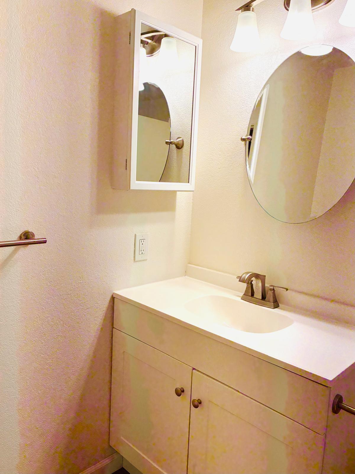 68-3883 Lua Kula Street, Unit 2102 Waikoloa, HI 96738 - Photo 7 of 21 a bathroom with a sink and a mirror