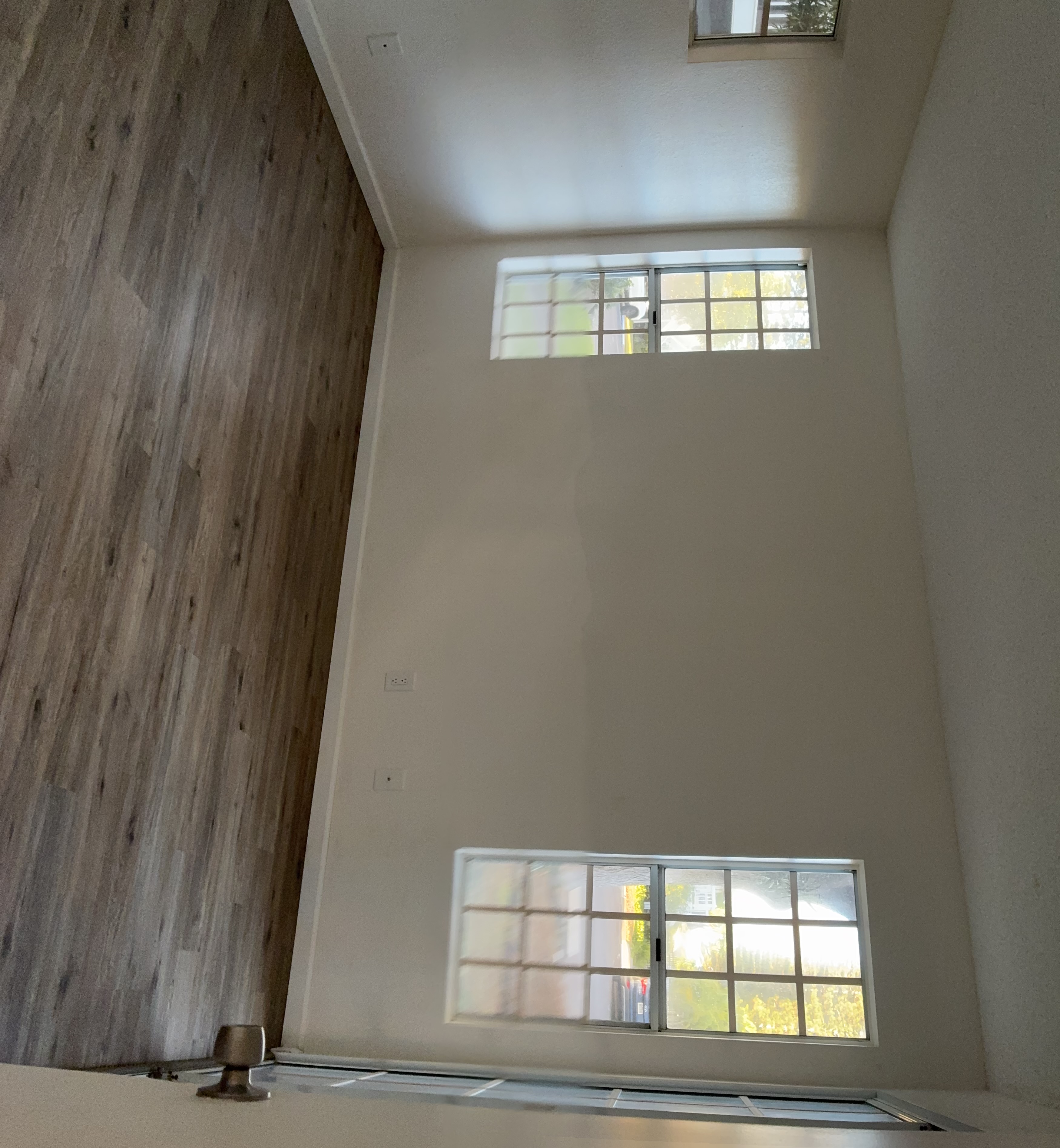 68-3883 Lua Kula Street, Unit 2102 Waikoloa, HI 96738 - Photo 8 of 21 an empty room with wooden floor and windows