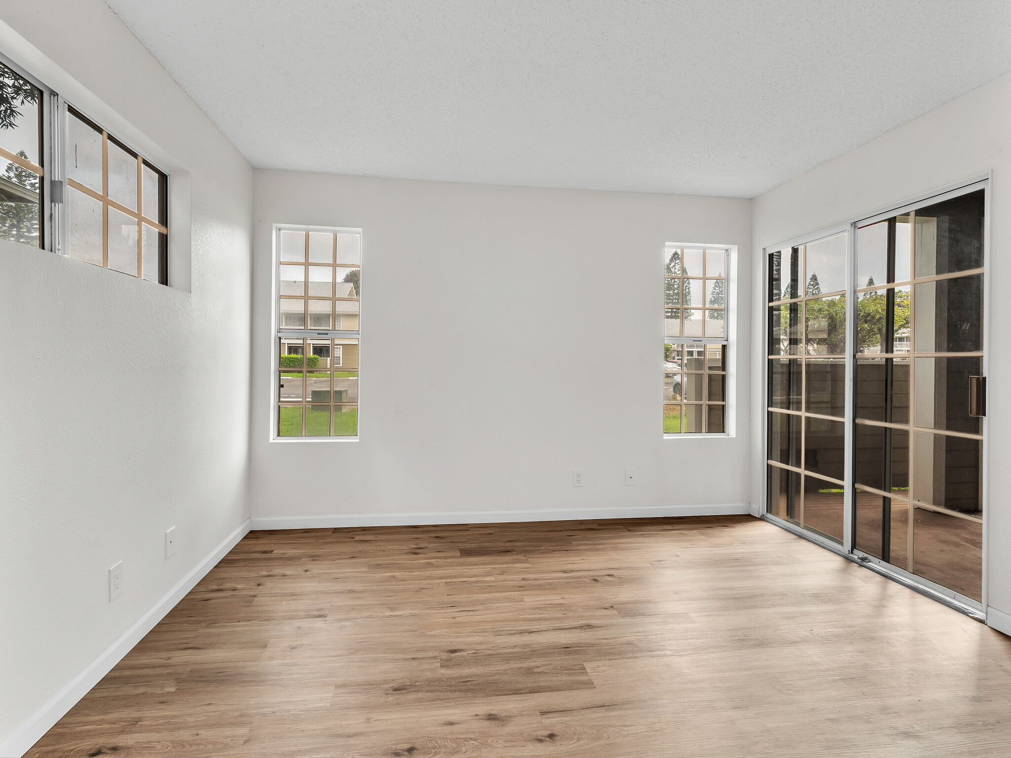 68-3883 Lua Kula Street, Unit 2102 Waikoloa, HI 96738 - Photo 10 of 29 wooden floor in an empty room with a window