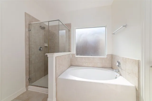 a bathroom with a tub and shower