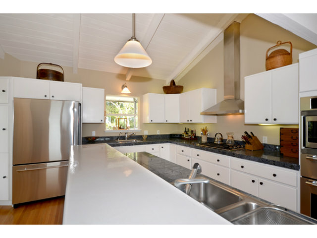 102 Las Lomas Drive Aptos, CA 95003 - Photo 3 of 25 a kitchen with stainless steel appliances a refrigerator a sink a stove and white cabinets