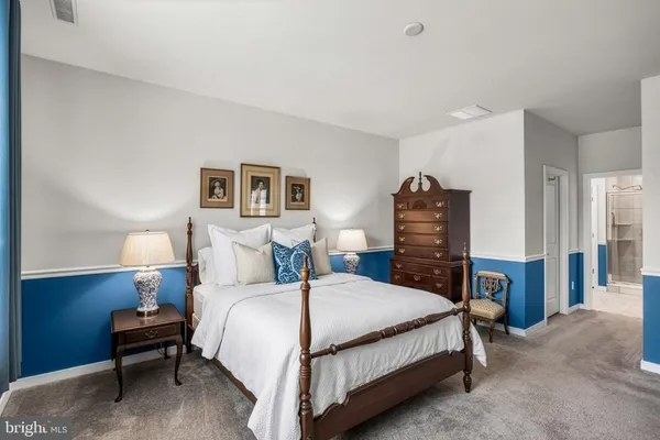 a bedroom with a bed and a night stand