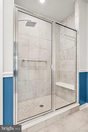a bathroom with a glass shower door