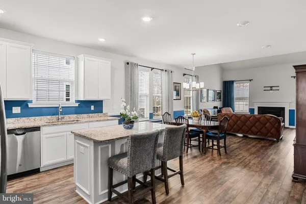 a kitchen with sink a granite counter tops and chairs