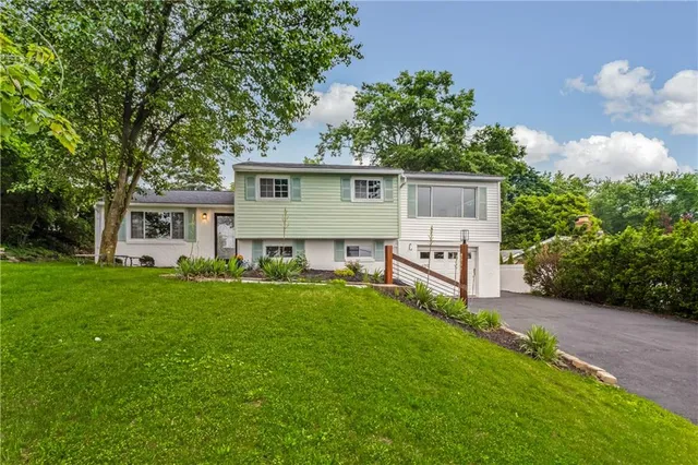 a view of a house with a yard and deck