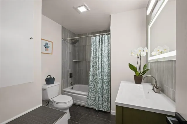 a bathroom with a sink toilet and shower