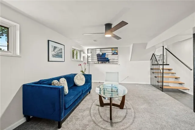 a living room with furniture and wooden floor