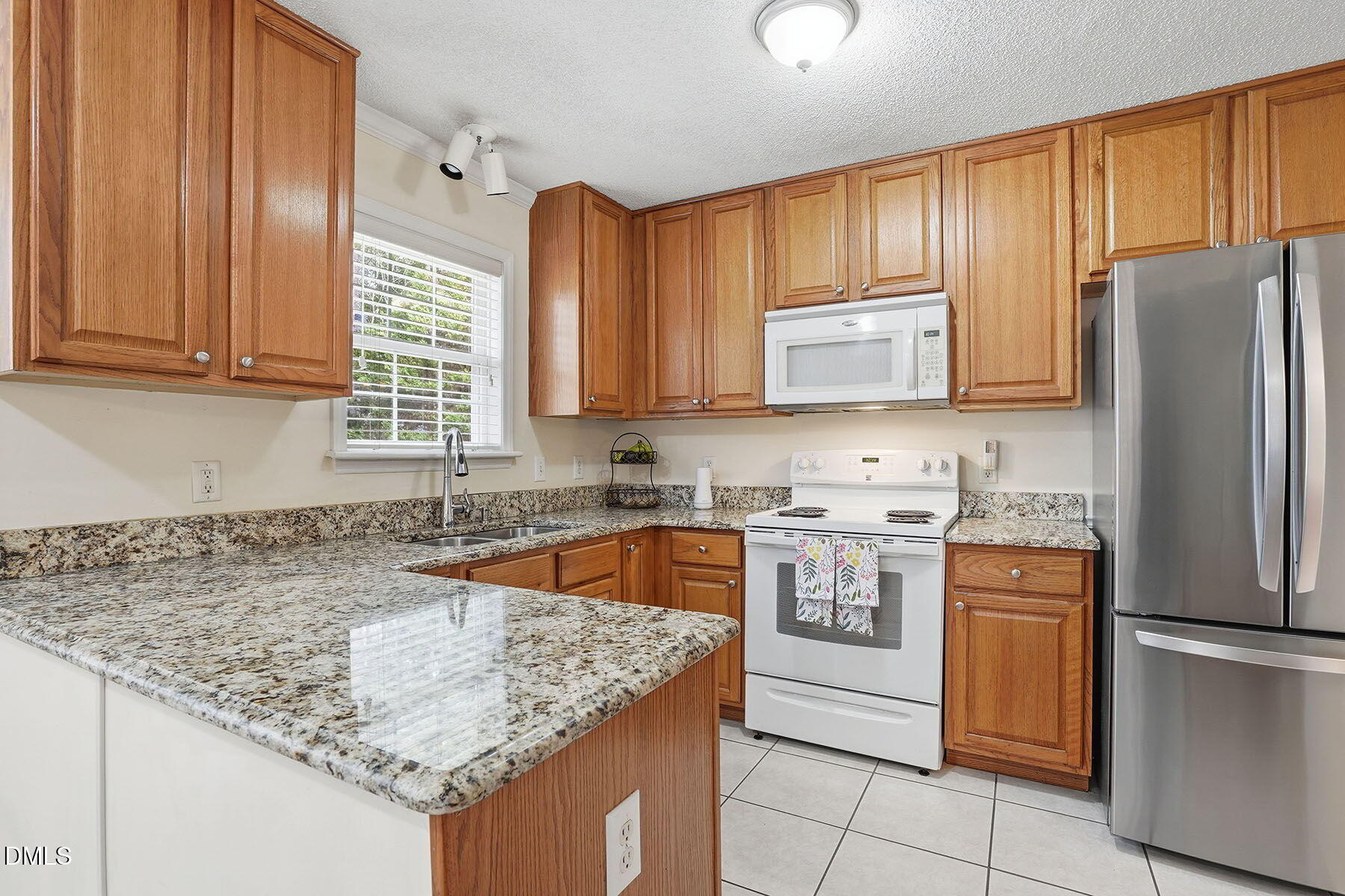 317 Atkinson Farm Circle Garner, NC 27529 - Photo 11 of 29 a kitchen with stainless steel appliances granite countertop a sink stove and refrigerator