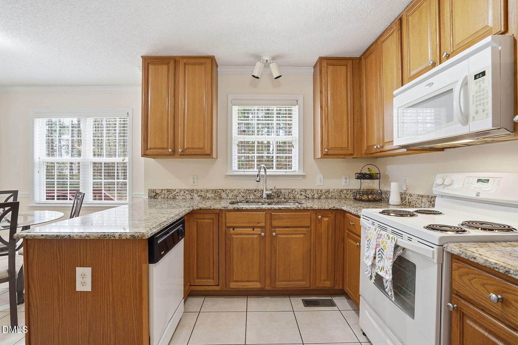 317 Atkinson Farm Circle Garner, NC 27529 - Photo 12 of 29 a kitchen with stainless steel appliances granite countertop a stove sink and cabinets