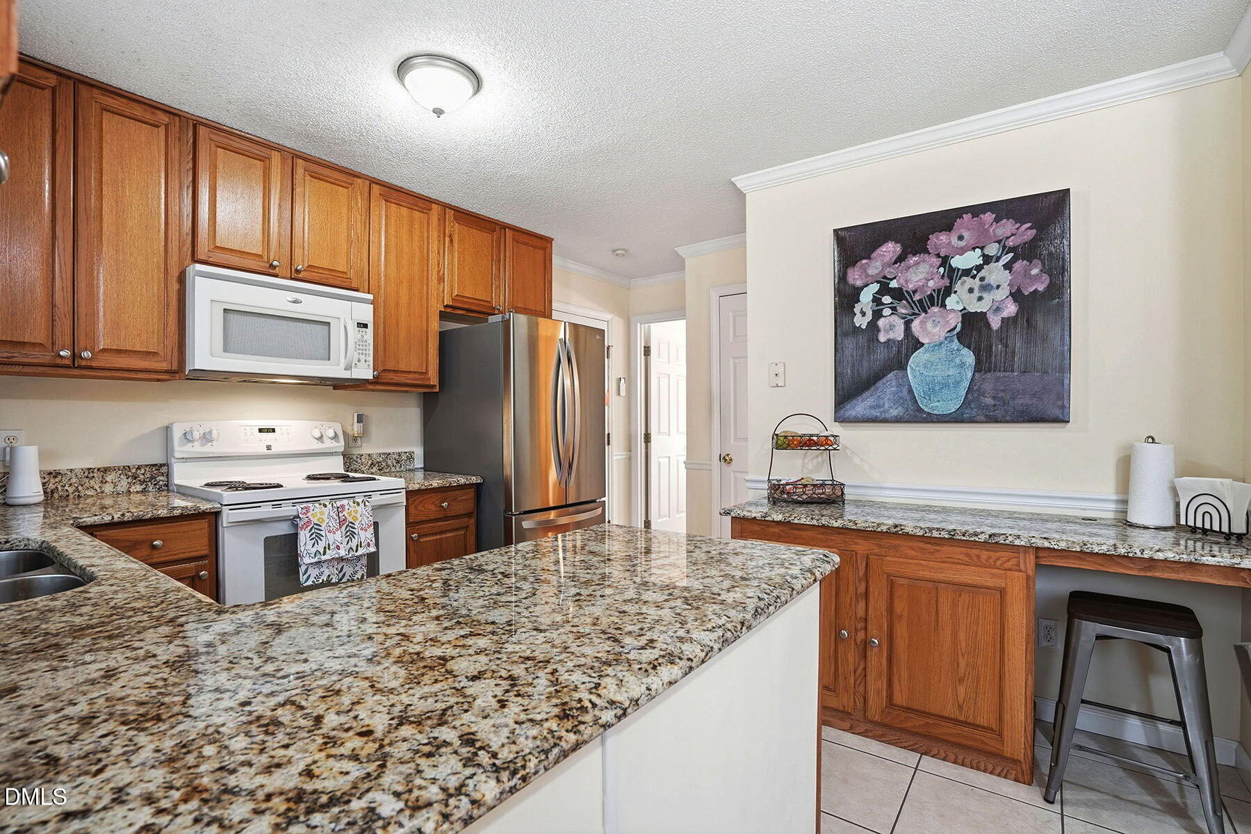 317 Atkinson Farm Circle Garner, NC 27529 - Photo 13 of 29 a kitchen with stainless steel appliances granite countertop a stove refrigerator sink and microwave