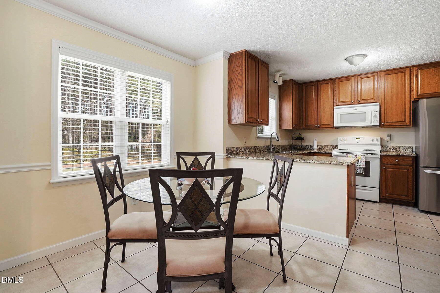 317 Atkinson Farm Circle Garner, NC 27529 - Photo 14 of 29 a kitchen with stainless steel appliances granite countertop a stove a sink a microwave and a refrigerator