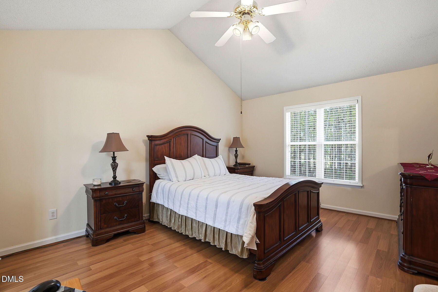 317 Atkinson Farm Circle Garner, NC 27529 - Photo 17 of 29 a bedroom with a bed and wooden floor