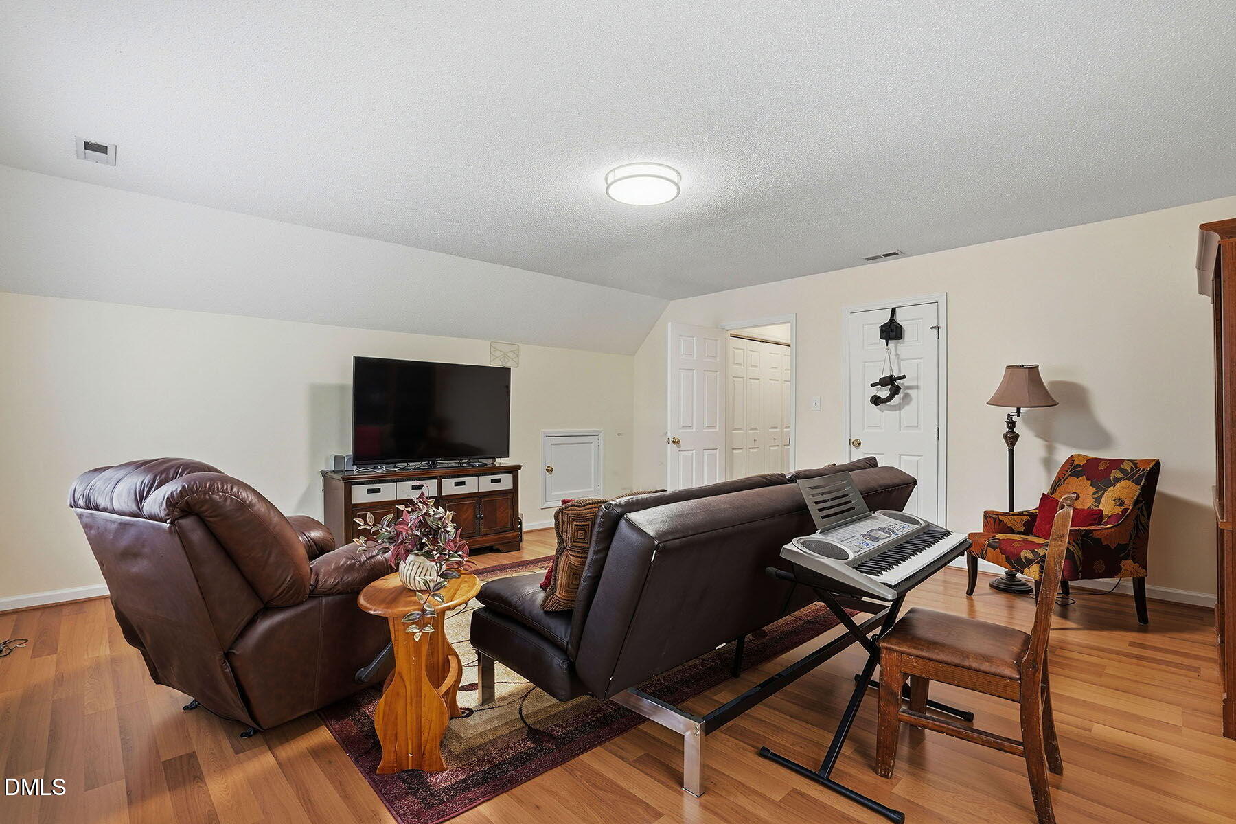 317 Atkinson Farm Circle Garner, NC 27529 - Photo 24 of 29 a living room with furniture and a flat screen tv