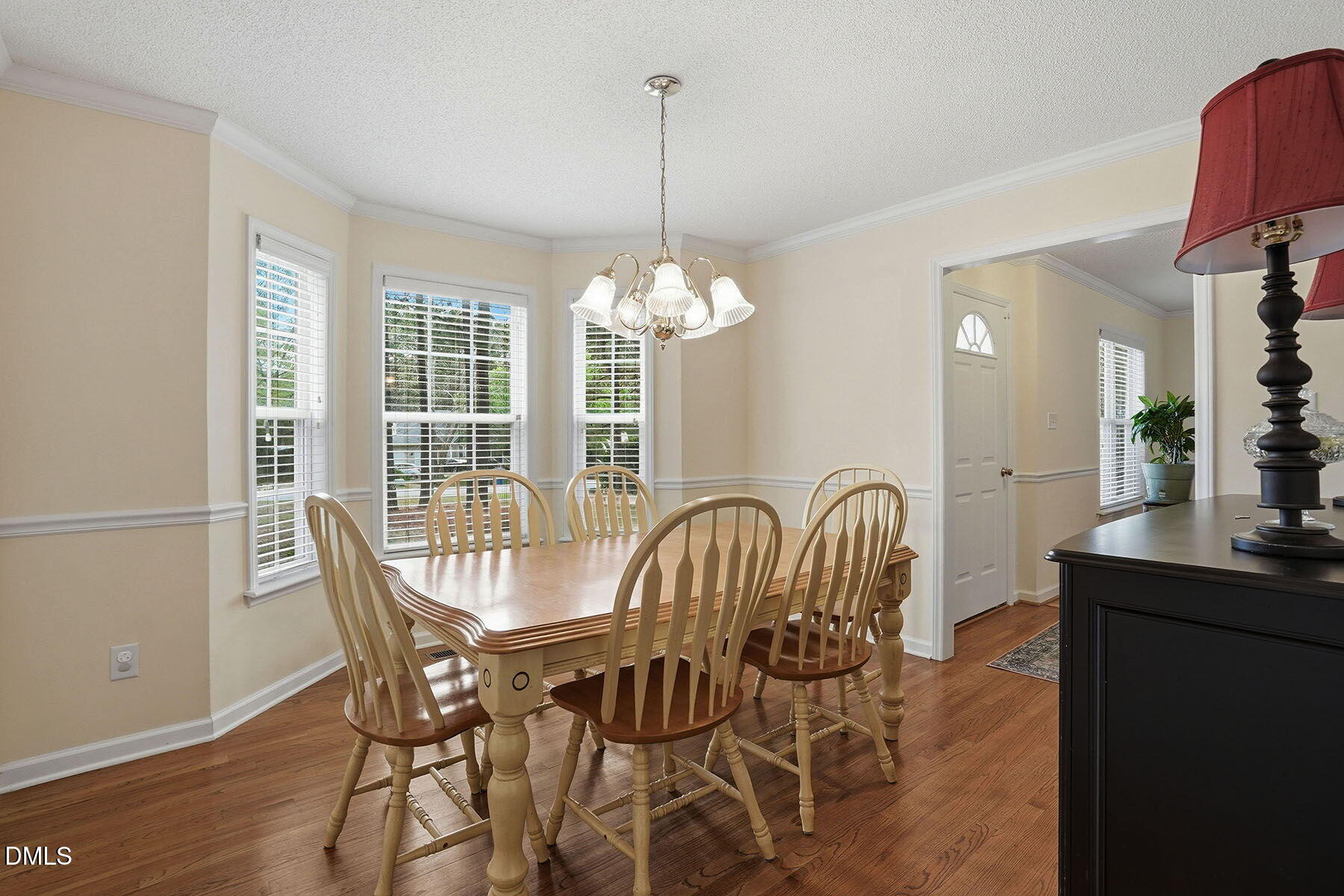 317 Atkinson Farm Circle Garner, NC 27529 - Photo 9 of 29 a dining room with furniture a chandelier and wooden floor