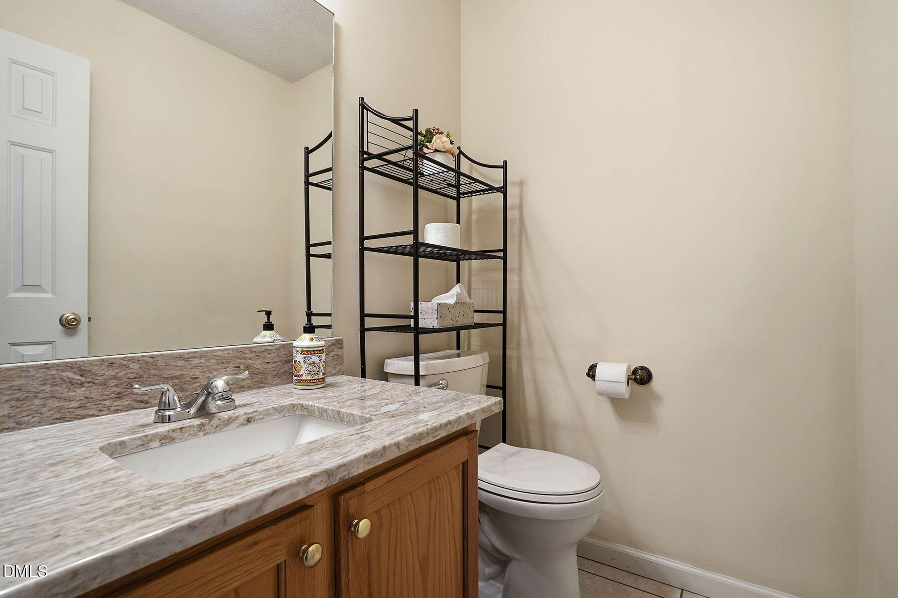 317 Atkinson Farm Circle Garner, NC 27529 - Photo 10 of 29 a bathroom with a granite countertop sink toilet and mirror