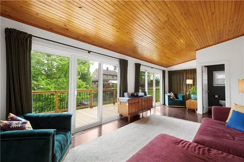 a living room with furniture and large windows