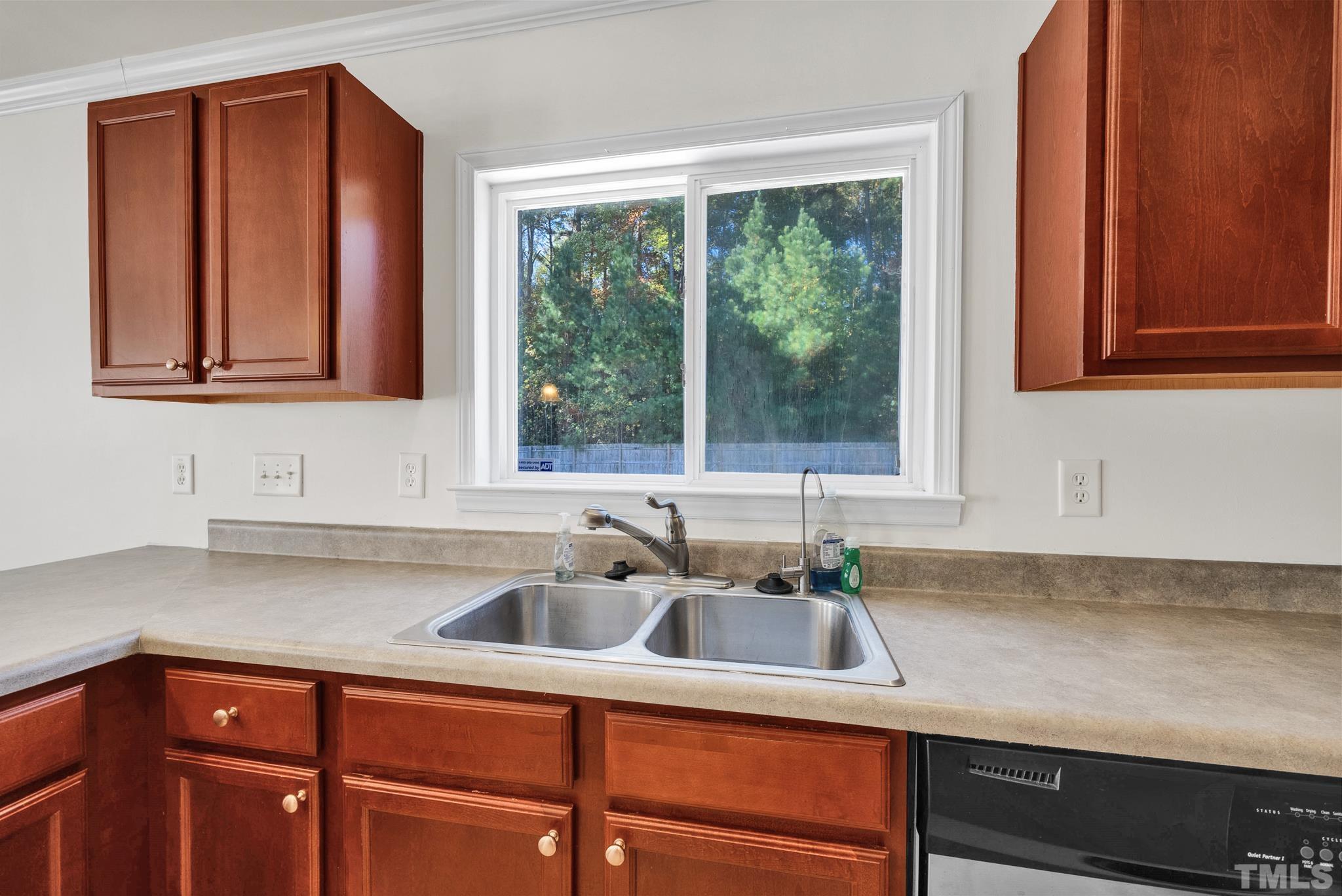 209 Lodestone Drive Durham, NC 27703 - Photo 12 of 30 a kitchen with stainless steel appliances granite countertop a sink a window and cabinets
