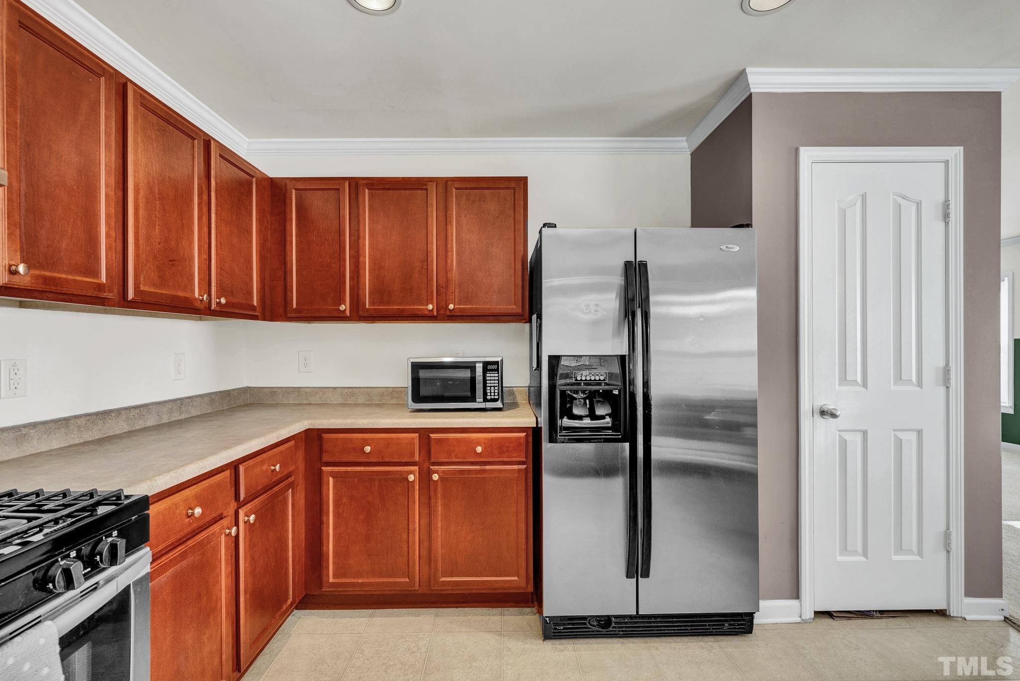 209 Lodestone Drive Durham, NC 27703 - Photo 13 of 30 a kitchen with stainless steel appliances granite countertop a refrigerator and a stove