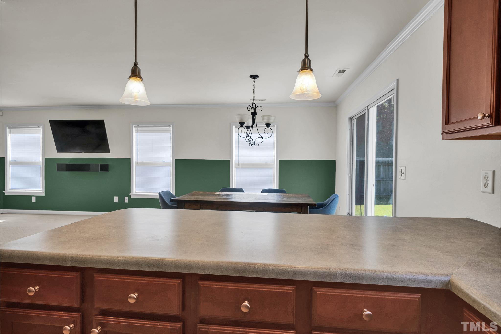 209 Lodestone Drive Durham, NC 27703 - Photo 14 of 30 a view of a kitchen with kitchen island a sink stainless steel appliances and cabinets