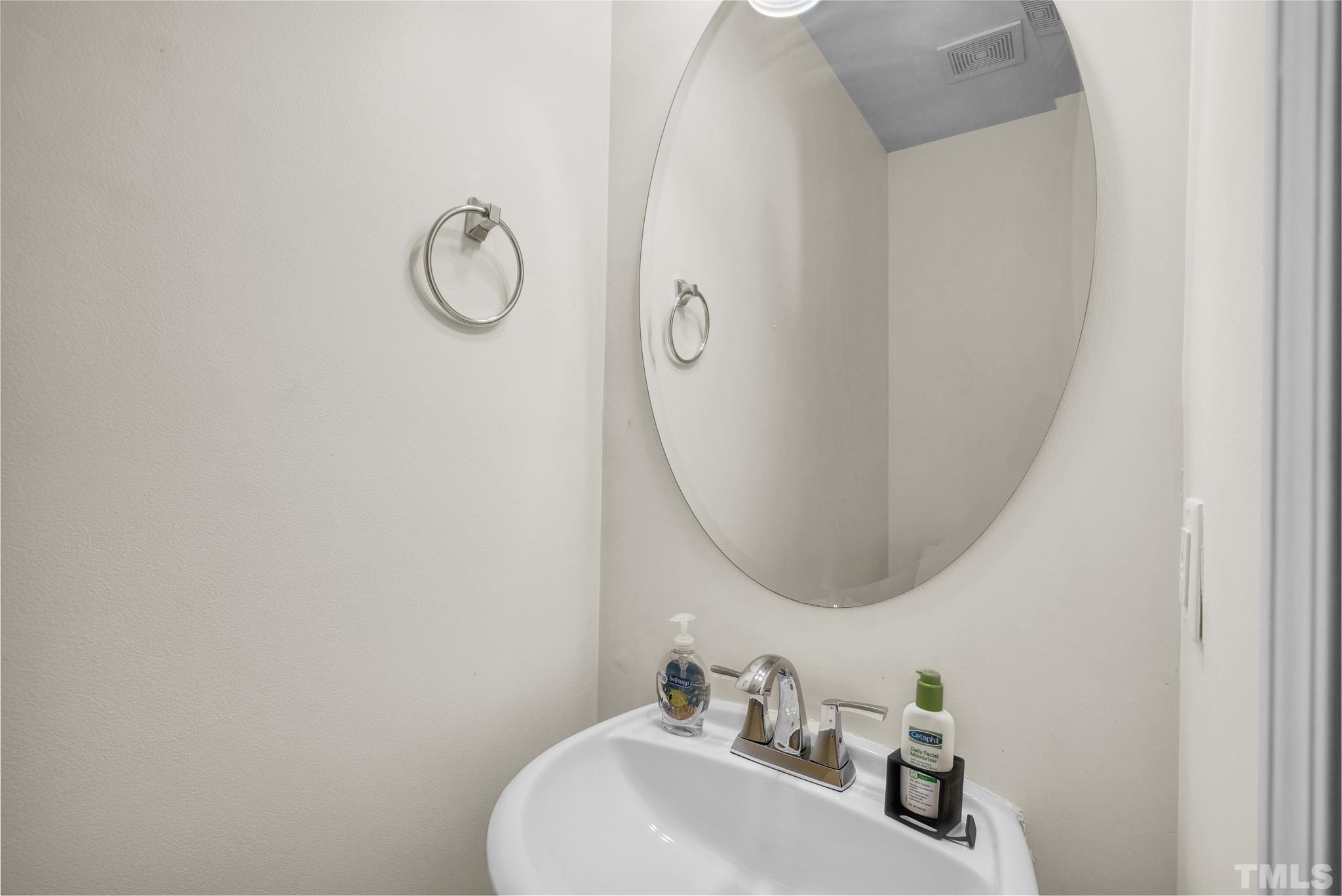 209 Lodestone Drive Durham, NC 27703 - Photo 15 of 30 a bathroom with a sink and mirror