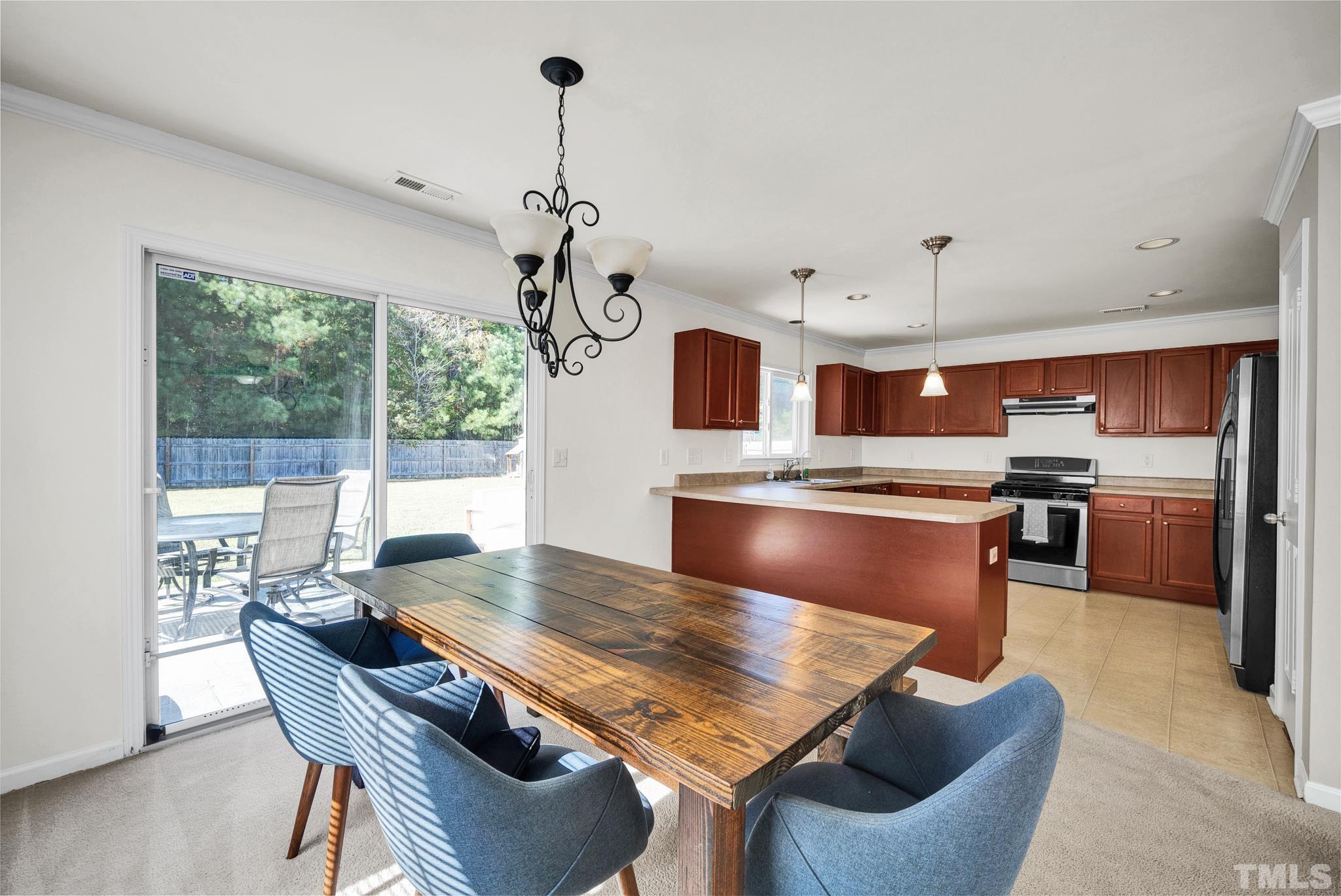 209 Lodestone Drive Durham, NC 27703 - Photo 7 of 30 a view of a dining room with furniture window and wooden floor