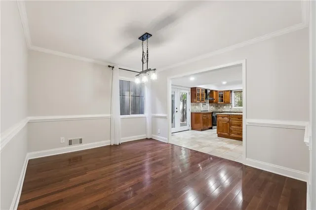 a view of a kitchen with wooden floor and a sink