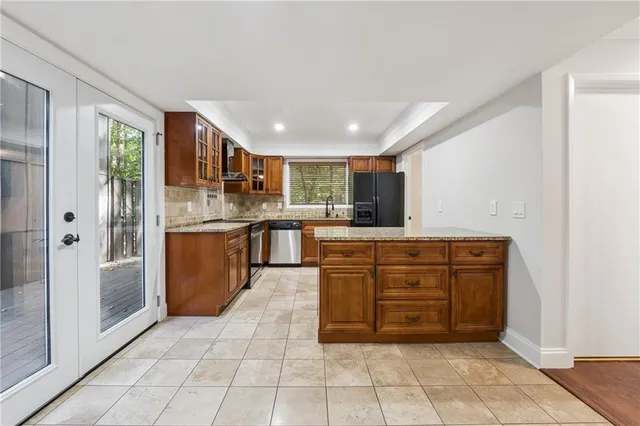 a kitchen with stainless steel appliances granite countertop a refrigerator and a sink