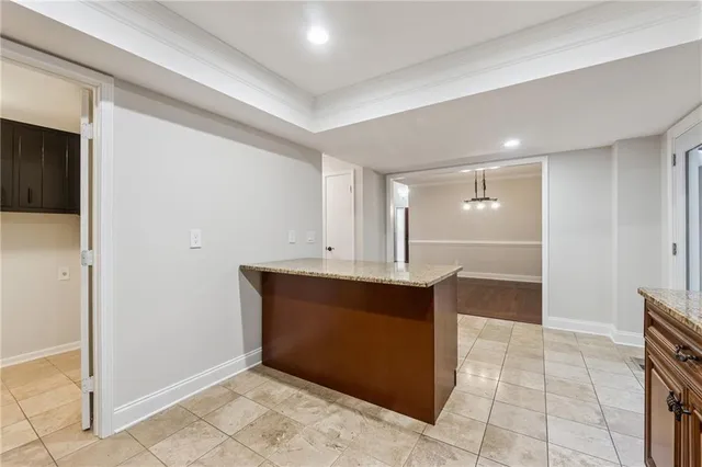 a view of kitchen with granite countertop cabinets