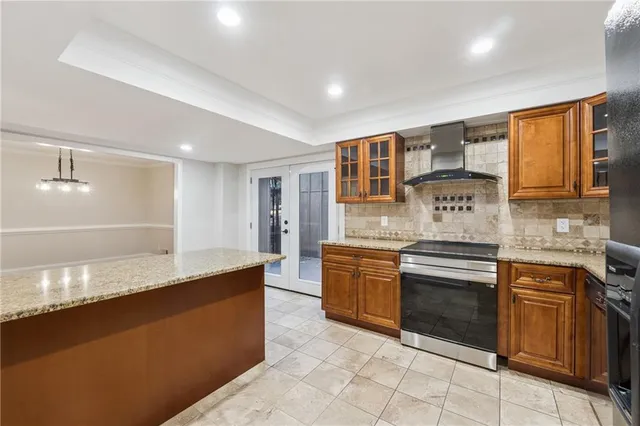 a large kitchen with stainless steel appliances granite countertop a stove and a sink
