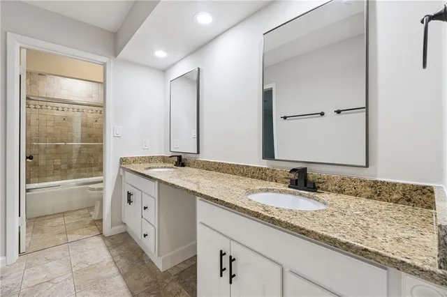 a bathroom with a granite countertop sink mirror and double