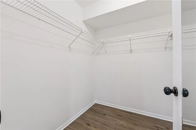 a view of a room with wooden floor and small rack