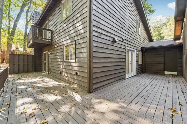 a view of a house with a wooden deck