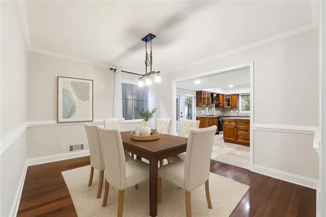a view of a dining room with furniture and wooden floor