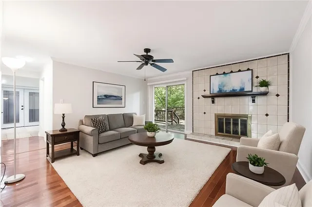 a living room with furniture a fireplace and a flat screen tv