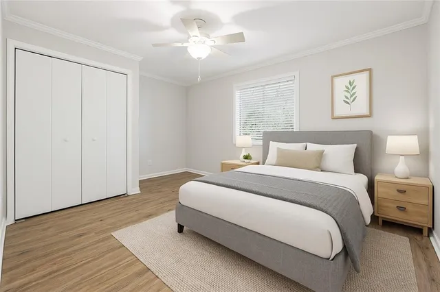 a spacious bedroom with a bed and a chandelier