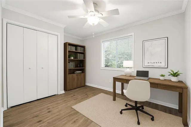 a workspace with chandelier fan and a window