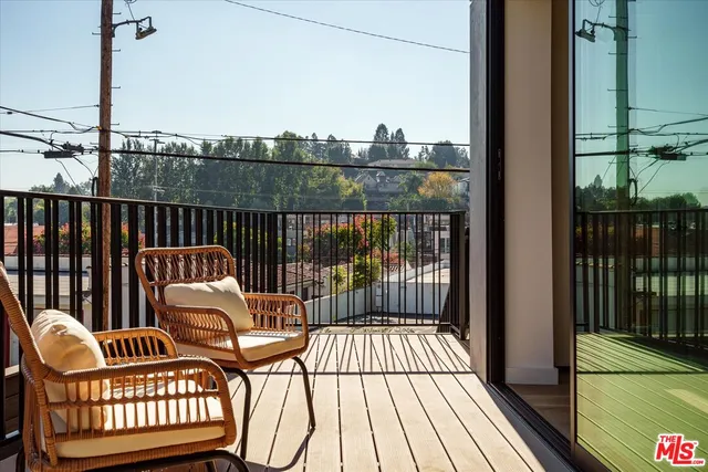 a view of a balcony with wooden floor