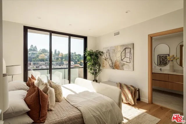 a bedroom with a large bed and a large window