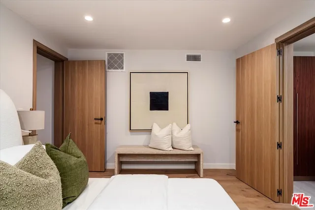 a bedroom with a bed and a mirror