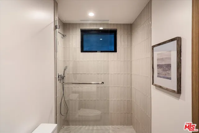 a bathroom with a shower and a sink