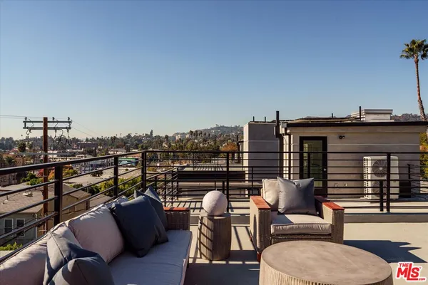 a view of roof deck with seating space and barbeque oven