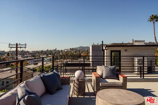 a view of roof deck with seating space and barbeque oven