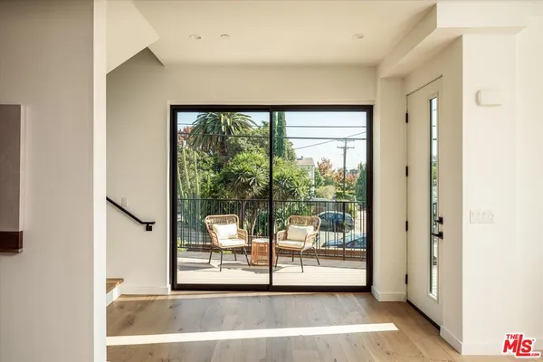 a view of a living room with a large window with front door