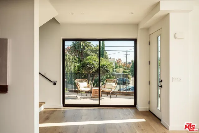 a view of a living room with a large window with front door