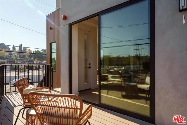 a view of a balcony with dining area