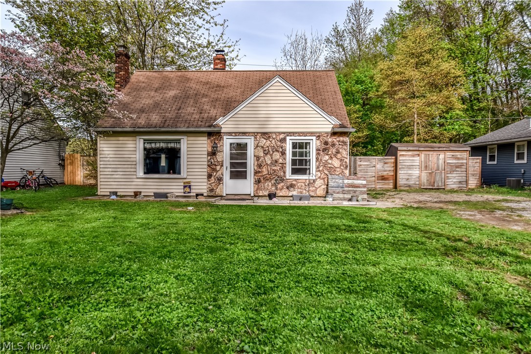 1969 Paisley Road Madison, OH 44057 - Photo 1 of 20 Front exterior featuring a stone and siding facade, a prominent chimney, and a gabled roofline