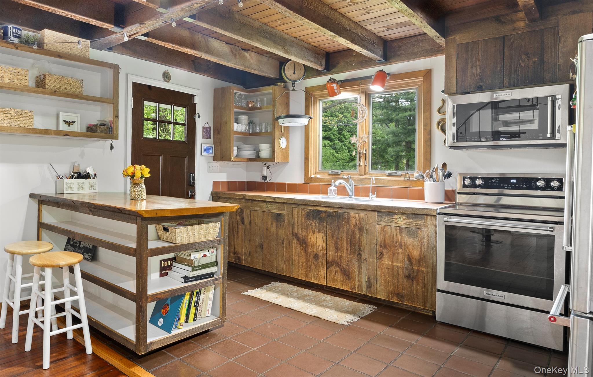 4 Clove Branch Road Hopewell Junction, NY 12533 - Photo 5 of 32 a kitchen with stainless steel appliances granite countertop a stove a sink and a refrigerator